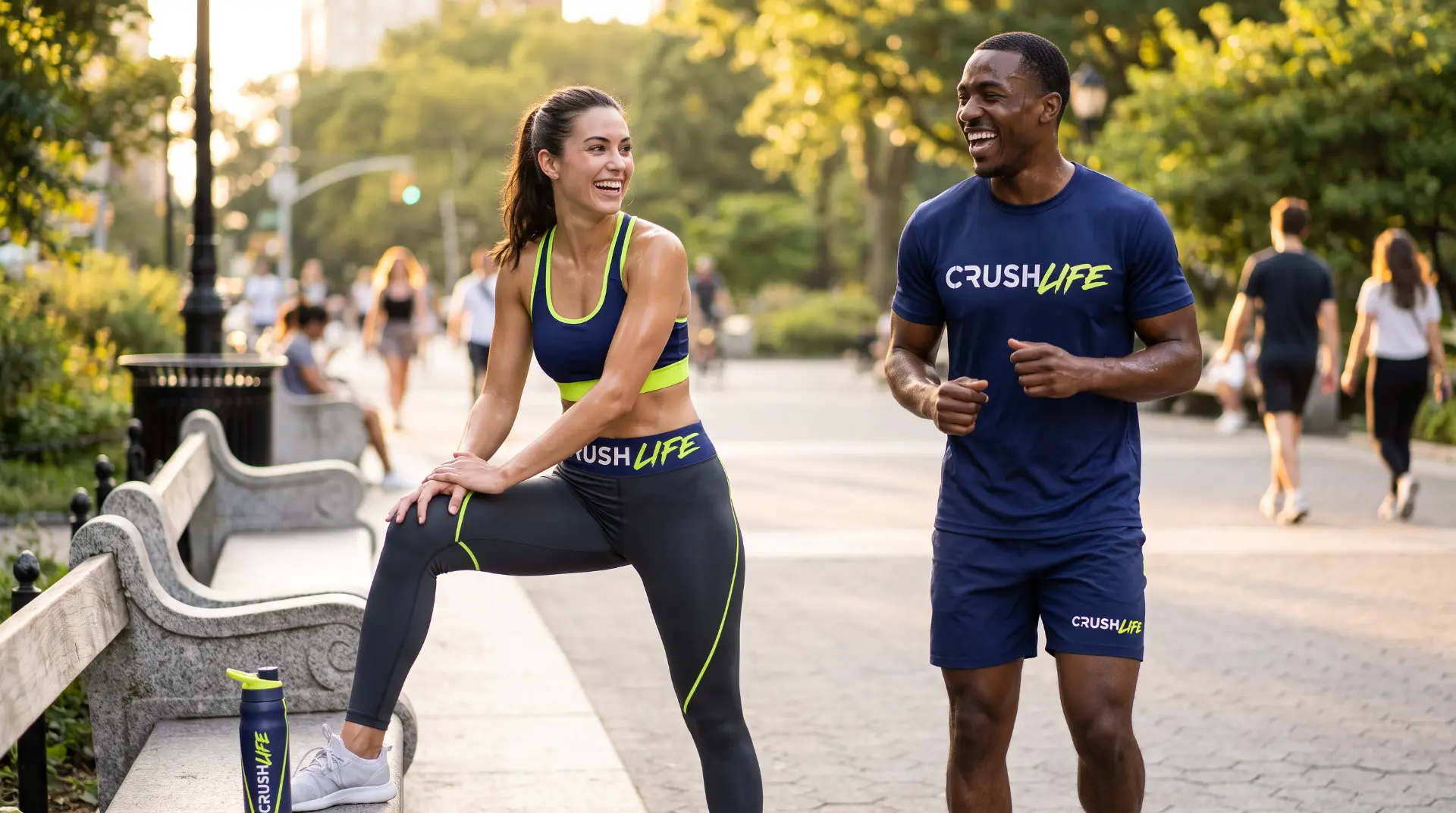 Two friends laughing mid-workout in a city park in Crush Life gear